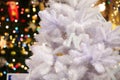 White fluffy Christmas tree with letters on the background of colorful lights Royalty Free Stock Photo