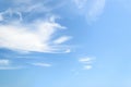 White fluffy cirrus clouds in a stratosphere. Light translucent fiber like spindrift clouds high in the blue summer sky. Different Royalty Free Stock Photo