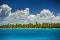 White fluffy clouds blue sky above a surface of the sea Royalty Free Stock Photo