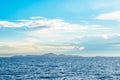 White fluffy clouds blue sky above a surface of the sea Royalty Free Stock Photo