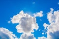 White fluffy clouds in the blue sky in the form of a human head with hair. The basis for the design. Royalty Free Stock Photo