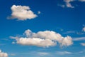 White fluffy clouds on blue sky at sunny day