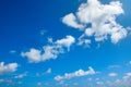 White fluffy clouds and bright sun on blue sky Royalty Free Stock Photo