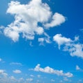 White fluffy clouds and bright sun on blue sky Royalty Free Stock Photo