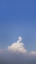 White fluffy clouds open for fantasy idea shape against bright blue sky for background with copy space, graphic resource, cloud Royalty Free Stock Photo