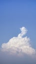 White fluffy clouds open for fantasy idea shape against bright blue sky for background with copy space, graphic resource, cloud Royalty Free Stock Photo