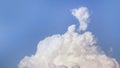 White fluffy clouds open for fantasy idea shape against bright blue sky for background with copy space, graphic resource, cloud Royalty Free Stock Photo