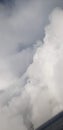 White fluffy clouds outside airplane window Royalty Free Stock Photo