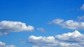 White fluffy clouds over blue sky on sunny day Royalty Free Stock Photo