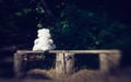 Sad lonely teddy bear and bench in the old garden