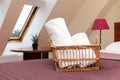 White fluffy towels rolled into a roll in a wicker basket in the hotel room Royalty Free Stock Photo