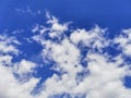 White fluffy volumetric cumulus clouds against a bright blue sky. Beautiful natural sky background Royalty Free Stock Photo
