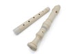 White flute recorder in two parts on a white isolated background, close-up Royalty Free Stock Photo