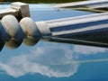 White fluted stone column fallen and partly submerged in water.