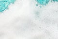 White foam blue water background closeup, sea or ocean foam wave pattern, froth bubbles texture, soap spume backdrop, soap sud