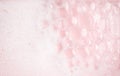 White foam bubbles texture on pink pastel background, copy space, banner for loundry, cleaning service, bathroom concept, clean, Royalty Free Stock Photo