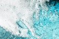 White foam clear blue water background closeup, sea or ocean foam wave border, froth bubbles texture, lather backdrop, soap suds Royalty Free Stock Photo