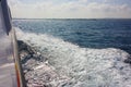 White foam trail left in the blue ocean sea waves by a water vessel Royalty Free Stock Photo