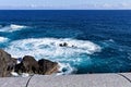 White foam of the waves crashing on the volcanic rock groynes in the Atlantic Ocean Madeira, Portugal Royalty Free Stock Photo