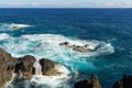 White foam of the waves crashing on the volcanic rock groynes in the Atlantic Ocean Madeira, Portugal Royalty Free Stock Photo