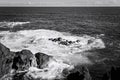 White foam of the waves crashing on the volcanic rock groynes in the Atlantic Ocean Madeira, Portugal Royalty Free Stock Photo