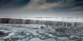 White foam waves roll through breakwater