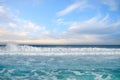 White foamy waves and gradually darkening color of sea