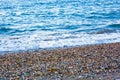 The white foamy waves on the pebble stones of the Mediterranean in Konyaalti Beach.