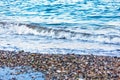 The white foamy waves on the pebble stones of the Mediterranean in Konyaalti Beach.