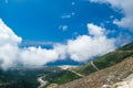 White fog high in mountains on Llogara pass. View from highlands on serpentine road to pass.Landscape of Albanian Riviera Royalty Free Stock Photo