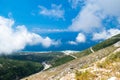 White fog high in mountains on Llogara pass. View from highlands on serpentine road to pass.Landscape of Albanian Riviera Royalty Free Stock Photo