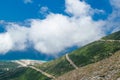 White fog high in mountains on Llogara pass. View from highlands on serpentine road to pass.Landscape of Albanian Riviera Royalty Free Stock Photo
