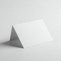 A white folded card stands on a smooth, white surface. The card is positioned at an Royalty Free Stock Photo