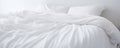 White folded duvet lying on white bed background. Preparing for household, domestic activities, hotel or home textile, white Royalty Free Stock Photo