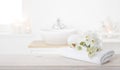 White folded spa towel and orchid flowers on wooden table Royalty Free Stock Photo