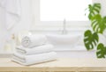 White folded towels on wooden table top in blurred bathroom Royalty Free Stock Photo