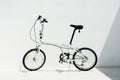 White folding bike on a white background