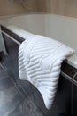 White foot towel in the bathroom . Concept of hotel business and recreation. Comfort and cleanliness in the bathroom. The view