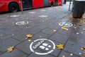 White footprints marked sign on the footpath at the bus stop