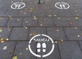 White footprints marked sign on the footpath at the bus, train or taxi stop