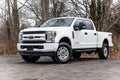 White 2020 Ford F-250 pickup truck with lifted wheels on a dirt road