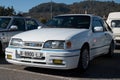 White Ford Sierra XR4I sports car in white with a blue line.