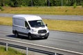 White Ford Transit Van Delivers Goods