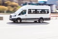 White Ford Transit van vehicle on city road. Fast moving car in Presnenskaya naberezhnaya street. Passenger van is fast transport Royalty Free Stock Photo