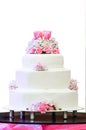 White four tiered wedding cake on table Royalty Free Stock Photo