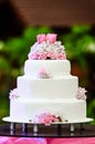 White four tiered wedding cake on table Royalty Free Stock Photo