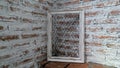White frame on brick show wall under light through roof in the room Royalty Free Stock Photo