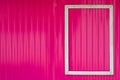 White frame on the bright pink wall. Royalty Free Stock Photo