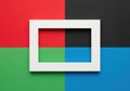 A white frame in the center of a colorful background with red, green, blue, and black sections Royalty Free Stock Photo