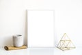 White frame and home decoration details on tabletop with wall, artwork poster mock-up Royalty Free Stock Photo